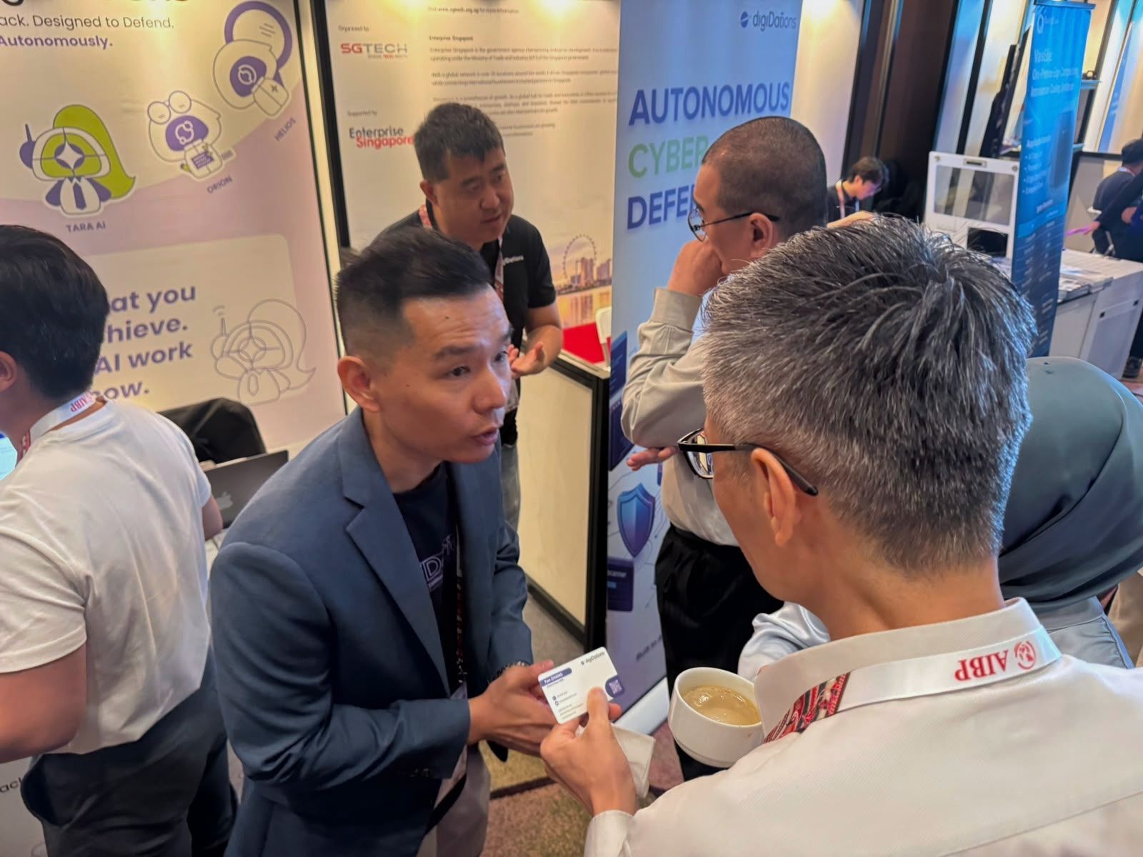 A digiDations representative in conversation with an attendee at the AIBP 2026 booth