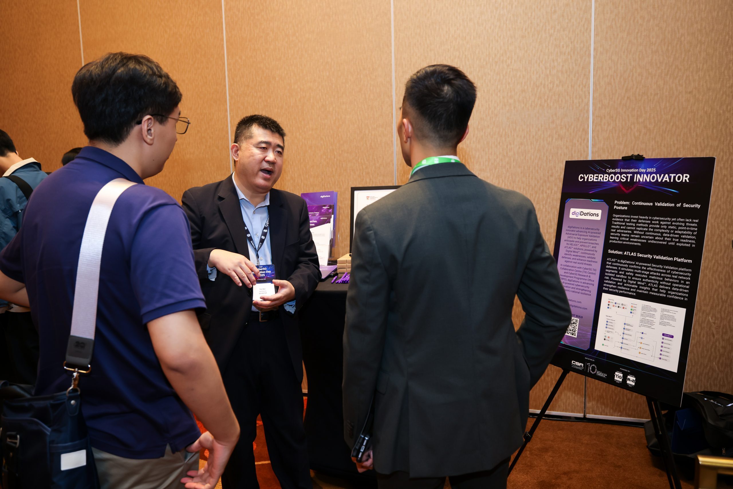Attendees viewing the CyberBoost Innovator poster at CyberSG Innovation Day 2025