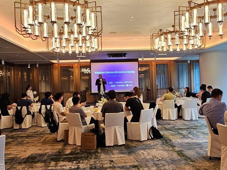 Guests seated at round tables during the Blockchain Security Luncheon Meeting