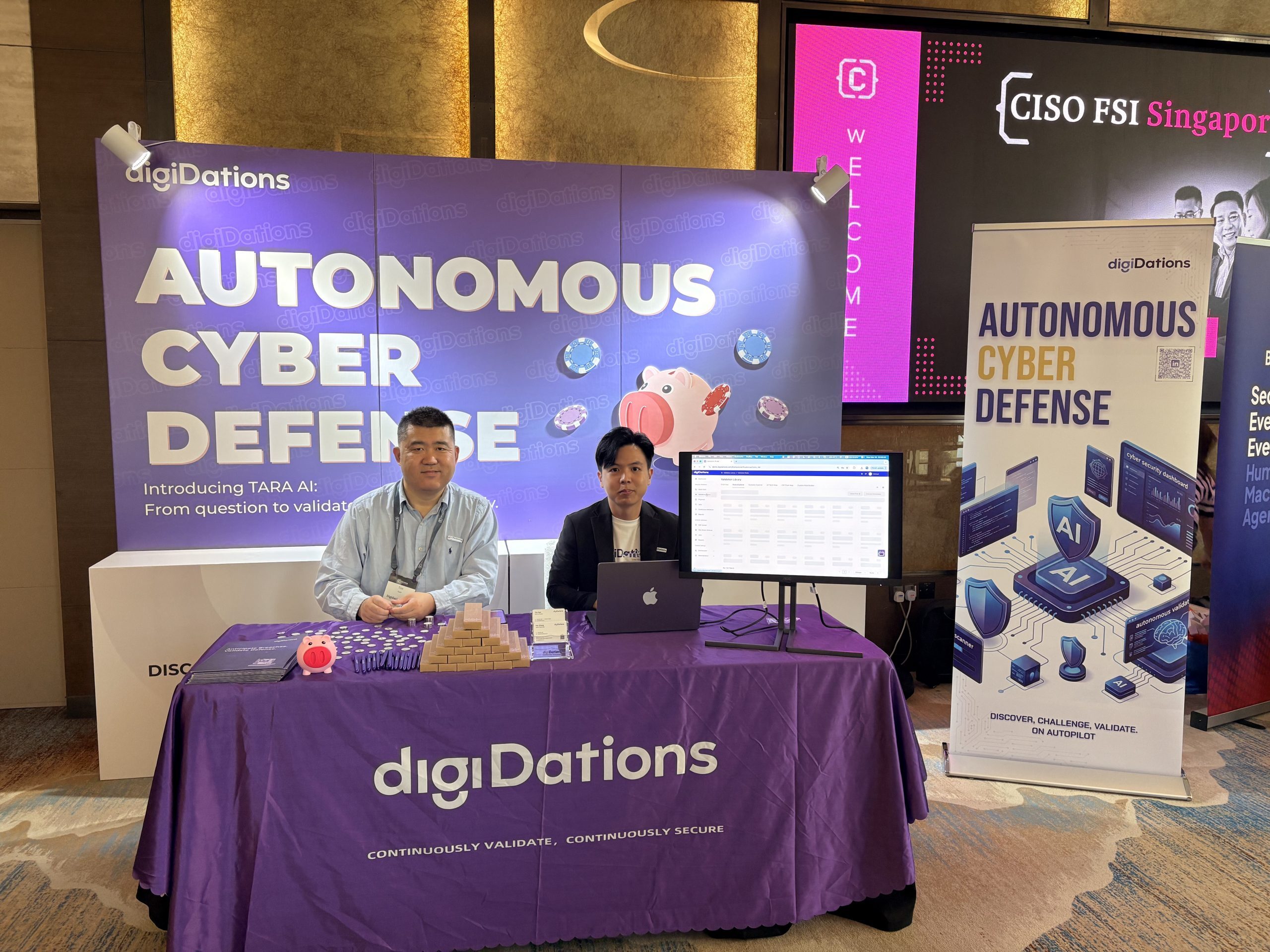 Two digiDations team members at the Autonomous Cyber Defense booth at CISO FSI Summit 2026 in Singapore