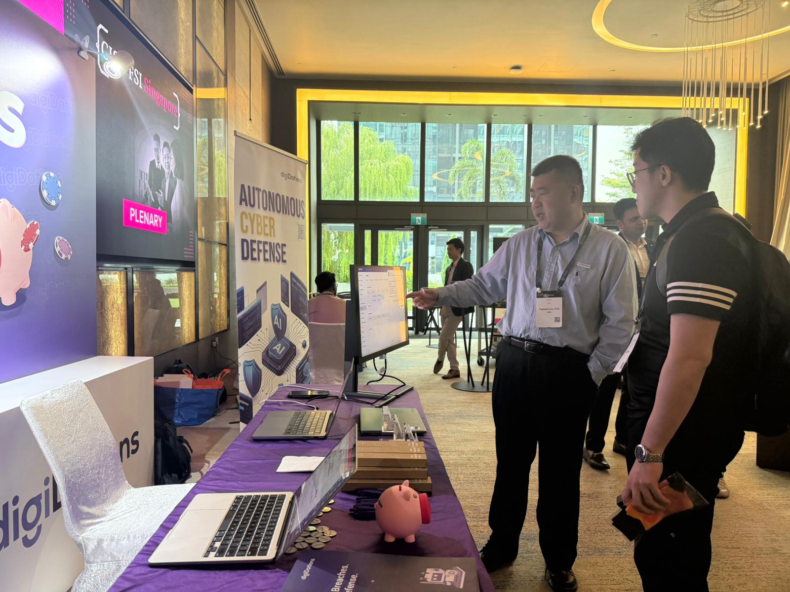 Attendees talking beside the digiDations demo table at CISO FSI Summit 2026