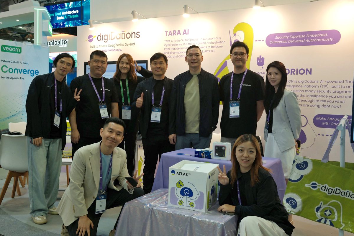 The digiDations team gathered at Booth D-02 at GovWare 2026 in front of the TARA AI and ORION wall graphics.