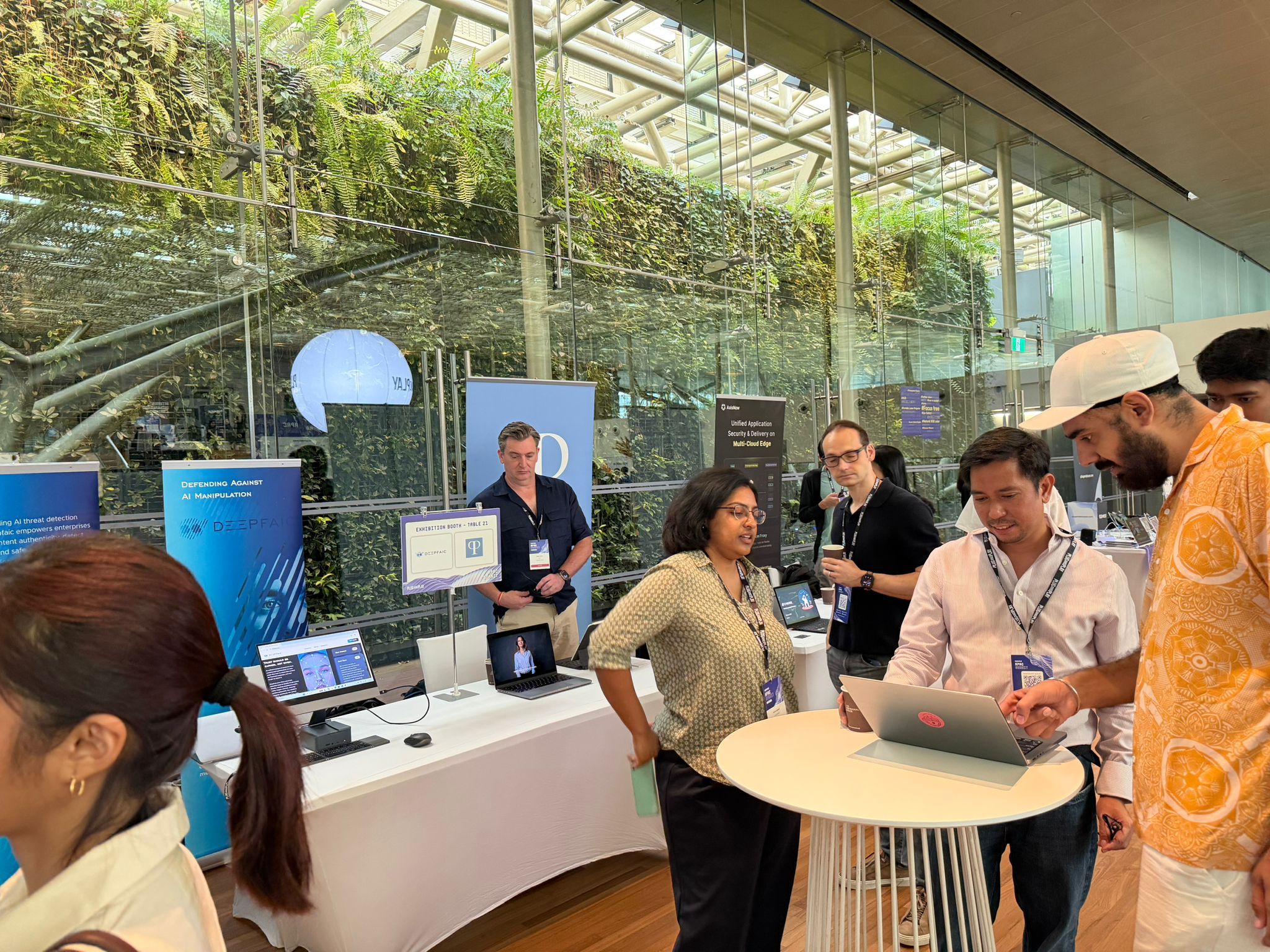 Visitors at the digiDations demo table at Plug and Play APAC 2025