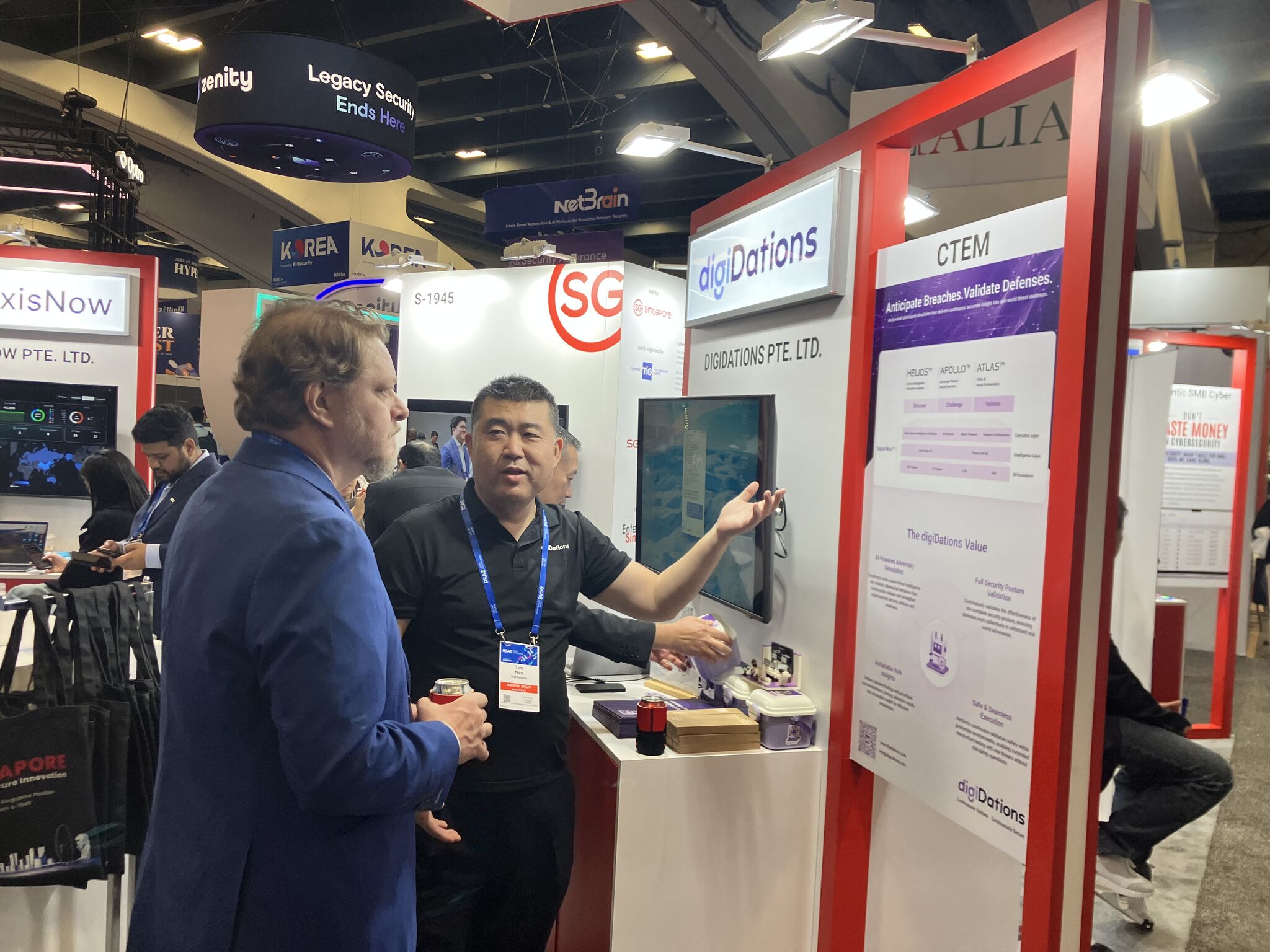 A digiDations team member demonstrating the platform on screen to a visitor at RSAC 2026